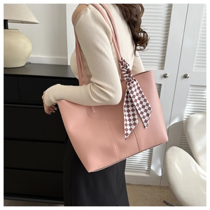 Detail of dusty rose tote bag with textured faux leather and checkered silk scarf accent