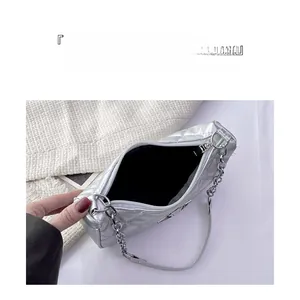 Silver quilted crossbody bag detail showing spacious interior and black lining storage