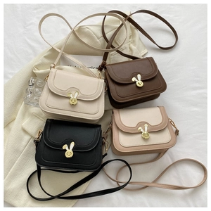 Flat lay of small crossbody bags in four colors featuring golden rabbit-ear metal buckles