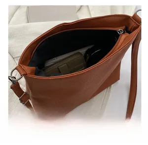 Interior view showing the large capacity of the brown lychee pattern crossbody tote bag