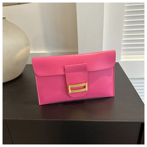 Close-up of rose pink leather envelope clutch featuring a gold rectangular metal buckle