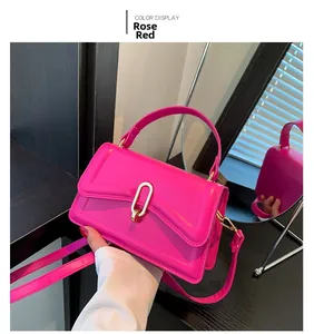 Detail view of rose red handbag with matte PU leather texture and gold oval metal lock