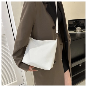 White lychee texture faux leather crossbody bag styled with a brown office blazer