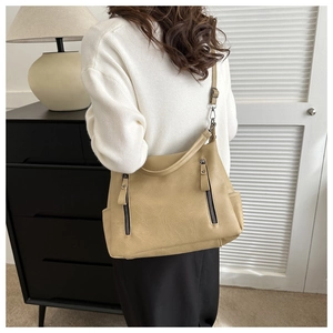 Detail view of large khaki tote bag with dual zippers and adjustable shoulder strap