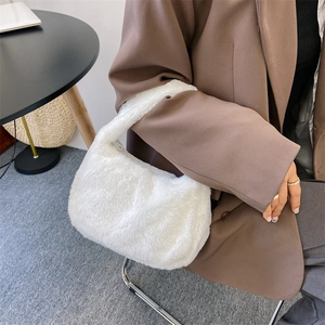 Minimalistische witte pluizige schoudertas van imitatiebont gedragen door een model