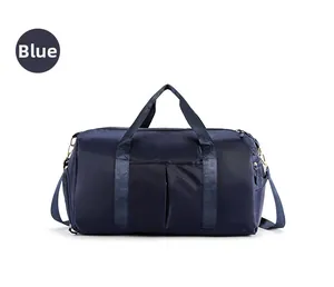 Detail view of a large blue travel bag with reinforced handles and functional side pockets