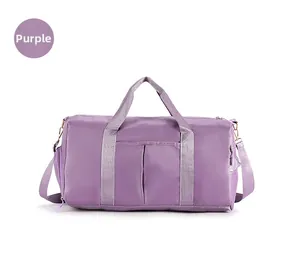 Detail view of purple nylon gym bag with dual handles and adjustable shoulder strap