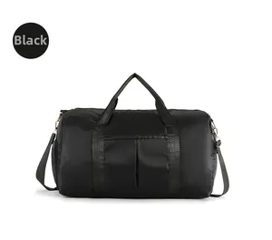 Detail view of black travel bag with waterproof nylon fabric and side shoe compartment