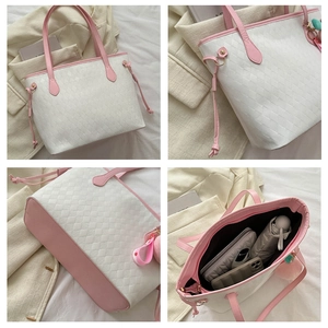Detail view of large quilted tote bag with spacious interior and pink contrast trim