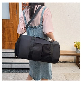 Outdoor fitness travel bag shown worn by a model in an urban cafe setting