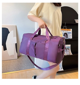 Detail of purple waterproof nylon gym bag with adjustable strap and silver zippers