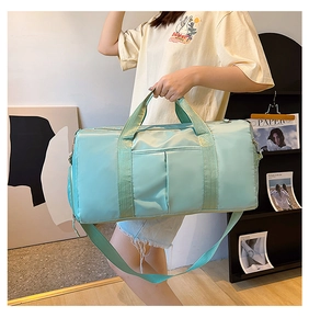 Detail of mint green gym bag with functional compartments and adjustable shoulder strap