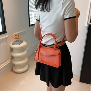 Minimalist orange epi leather crossbody bag with knot handle and detachable strap