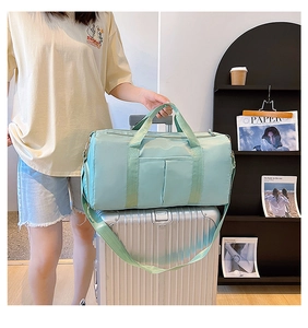 Mint green waterproof yoga travel bag detail showing handle and suitcase strap attachment