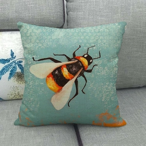Close-up of linen pillowcase with hand-painted bumblebee on textured teal background
