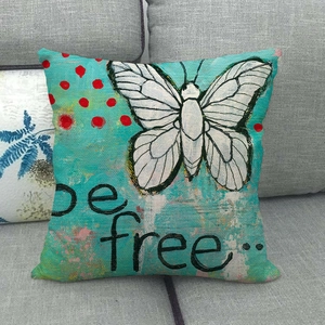Detail view of cotton linen pillow cover with butterfly print and be free text on sofa