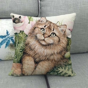 Linen pillow cover featuring a fluffy cat and pink floral art on a gray sofa