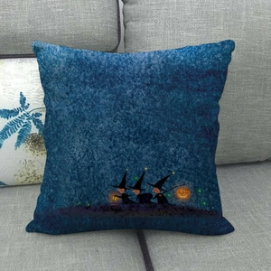 Halloween linen pillow case featuring wizards and glowing pumpkins on a blue sofa background