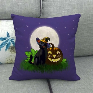 Halloween black cat and pumpkin witch hat print on purple linen pillowcase on a sofa