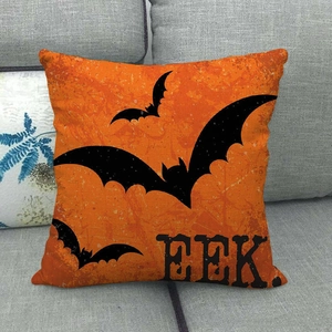 Detail of orange linen Halloween pillowcase with black bats and EEK text on sofa