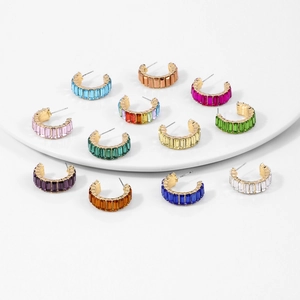 Golden C-shaped earrings set with colorful rectangular crystals and vibrant gemstones