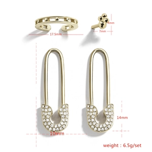 Detailed view of 4pcs gold earring set including rhinestone safety pin drops and ear cuff