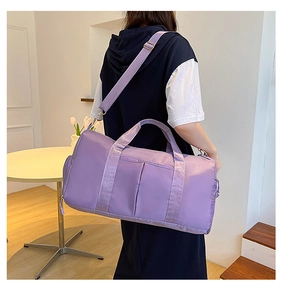 Detailed macro view of the purple fitness bag with dual handles and adjustable shoulder strap