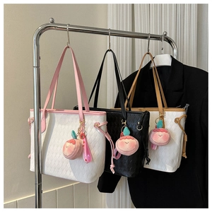 Detailed close-up of quilted tote bags in various colors on a stylish metal display rack