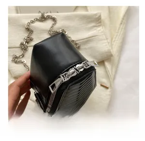 Detail of silver smooth double metal zippers on black quilted coffin crossbody bag