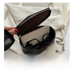Detail view of the black leather bag interior showing capacity for phone and glasses