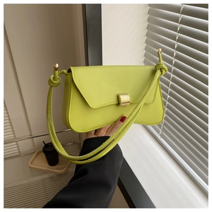 Detailed shot of lime green baguette bag featuring a gold square buckle and knotted strap