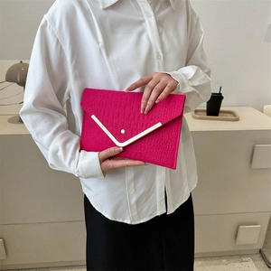 Fuchsia crocodile embossed envelope clutch bag with gold V-shape metal trim accents