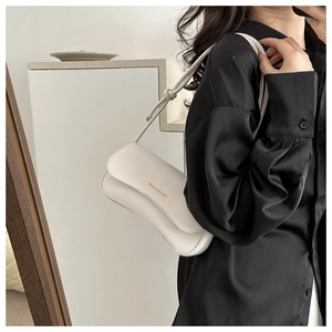 Detail view of white leather shoulder bag with golden Fashion & Bags logo on the front flap