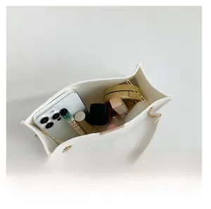 Top view of spacious white felt tote interior showing capacity for phone and cosmetics