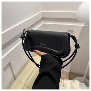 Detail der minimalistischen schwarzen Kunstledertasche mit goldenem XM & BAGS Logo