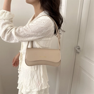 Minimalist beige leather baguette bag with knotted shoulder strap for women