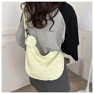 Detail of light green pleated hobo bag with a matching small coin purse on the shoulder strap