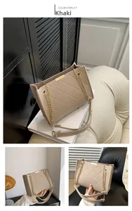 Detail of khaki felt crossbody bag featuring diamond quilted texture and gold chain strap