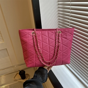 Deep pink quilted tote bag with golden chain strap for women casual commuting look