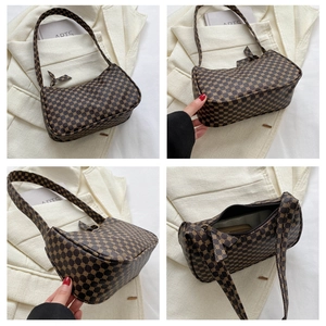 Detail view of vintage geometric pattern shoulder bag showing side and interior pocket