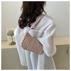 Detail view of pink geometric pattern shoulder bag with a vintage half-moon silhouette