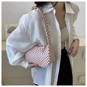 Pink monogram shoulder bag worn with white shirt and beige top for a trendy commute look