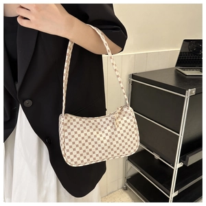 Detail of minimalist beige faux leather shoulder bag with vintage geometric pattern
