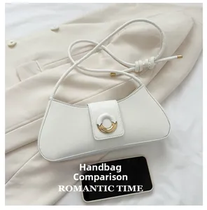 Detailed view of white curved underarm bag with gold ring buckle and phone size comparison
