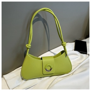 Detail of lime green baguette bag featuring round metal buckle and knotted leather handle