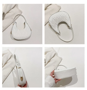 Detailed views of white quilted crescent bag with wave patterns and gold hardware