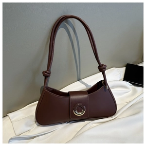 Detail of dark brown shoulder bag with sleek PU finish and metal ring buckle detail
