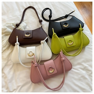 Detail of five-color vintage underarm bags showing metal buckles and knotted straps