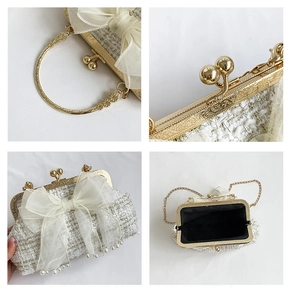 Detail of white tweed evening bag with organza bow, pearl fringe and gold metal handle