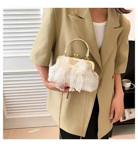 White tweed shell handbag with gold chain and large sheer bow detail on blazer outfit